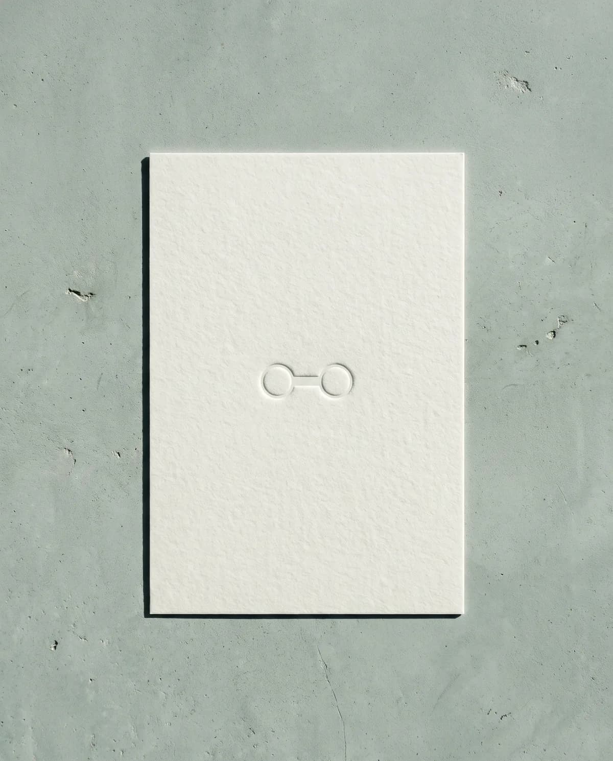 Hansala's mark embossed into a sheet of paper on concrete